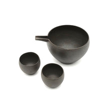 Set of black ceramic teapot and two cups on a white background