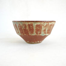 Ceramic bowl with decorative patterns on a white background