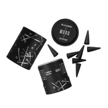 Black and white incense packaging with cones on a white background