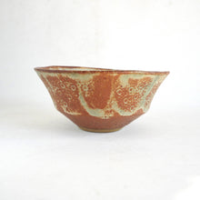 Ceramic bowl with textured surface on a white background