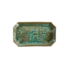 Rectangular ceramic dish with textured surface on a white background