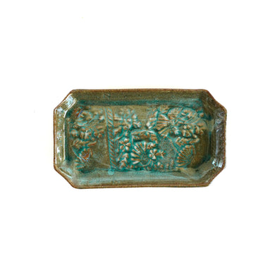 Rectangular ceramic dish with textured surface on a white background