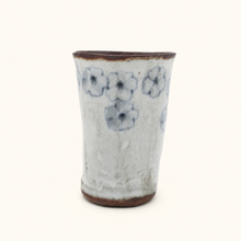 Spako Clay tumbler with blue floral patterns on a white background