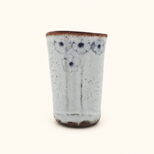 Spako Clay tumbler with blue floral patterns on a white background