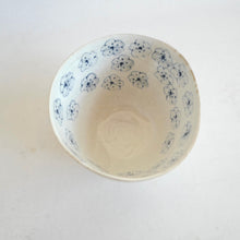 Ceramic bowl with blue floral patterns on a white background