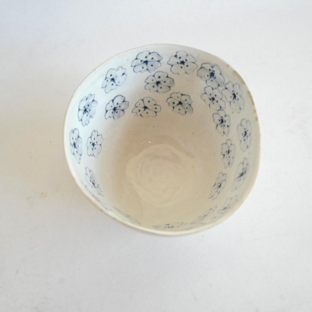 Ceramic bowl with blue floral patterns on a white background