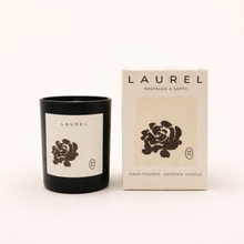 Candle in black holder and beige box packaging with “Laurel” label