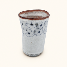 Spako Clay tumbler with blue floral patterns on a white background