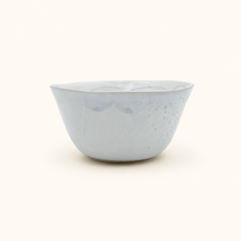 White ceramic bowl with speckled texture on a white background