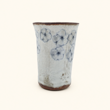 Spako Clay tumbler with blue floral patterns on a white background