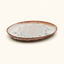 Ceramic plate with a rustic design on a white background