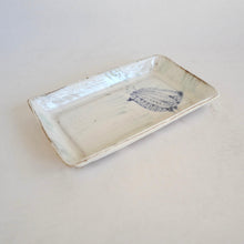 Rectangular ceramic tray with a blue design on a light gray background