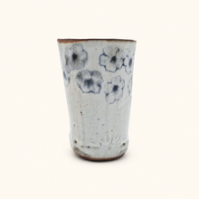 Spako Clay tumbler with blue floral patterns on a white background