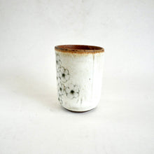 Ceramic cup with floral design on a white background