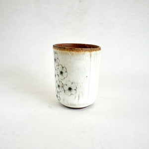Ceramic cup with floral design on a white background
