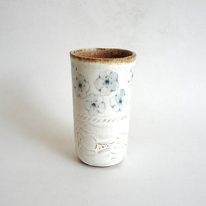 Spako Clay tumbler black line drawing of flowers and emboss pattern, white glaze