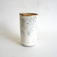 Spako Clay tumbler blue line drawing of flowers and emboss pattern, white glaze