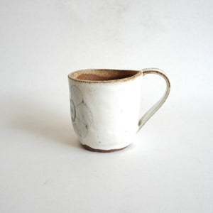 Spako Clay mug. Blue line flower drawing, white glaze