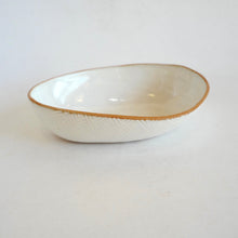 White ceramic bowl with a brown rim on a white background