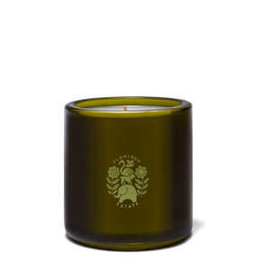 Green candle in a glass jar with a logo on a white background