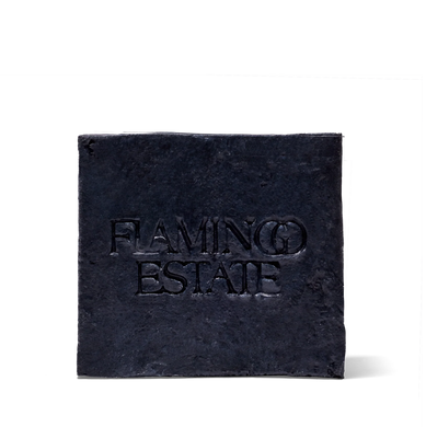 Black square soap with 'Flaming Estate' text on a white background