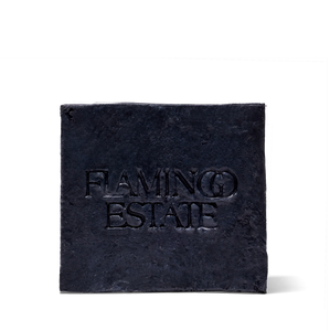 Black square soap with 'Flaming Estate' text on a white background