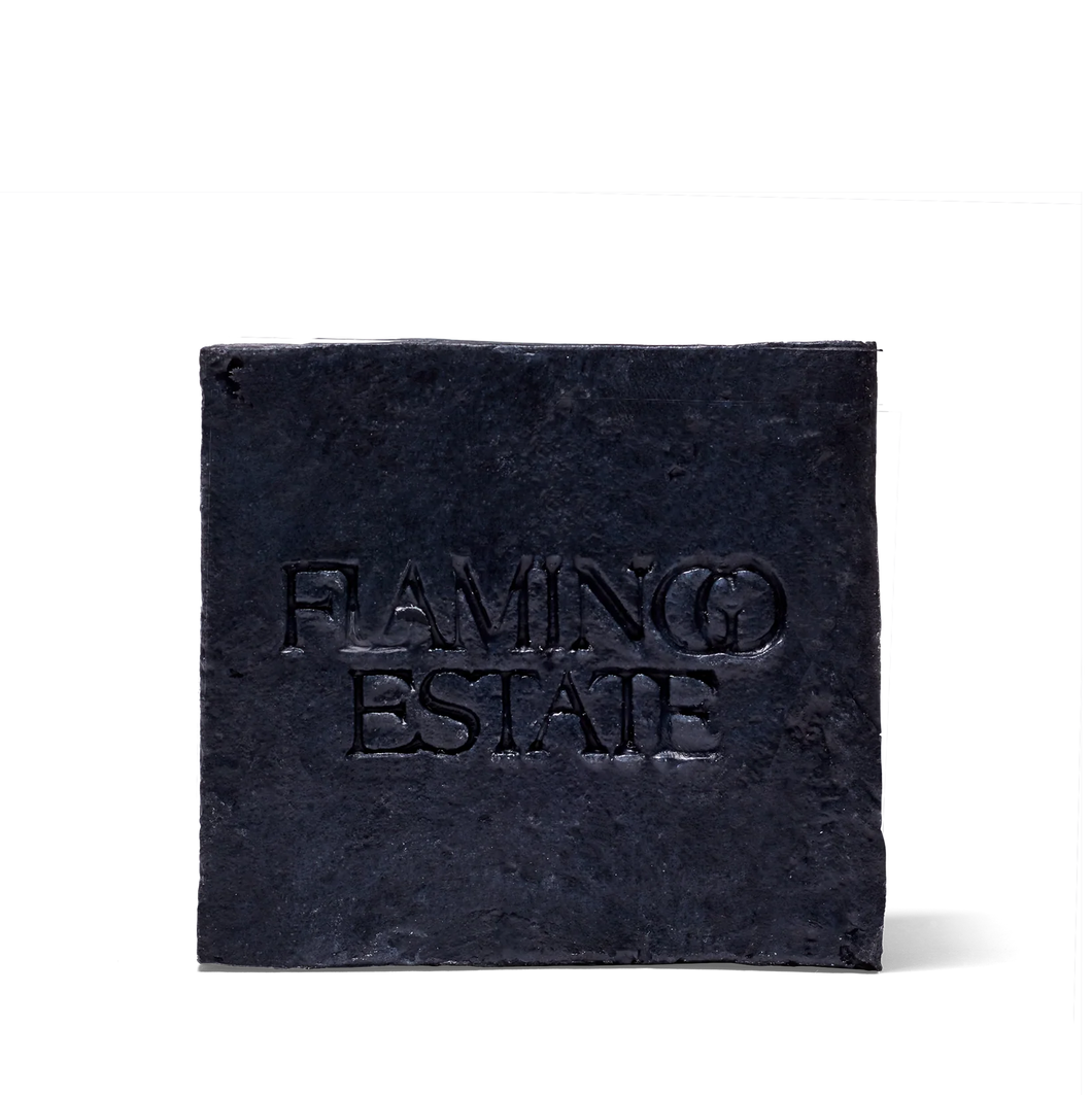 Black square soap with 'Flaming Estate' text on a white background
