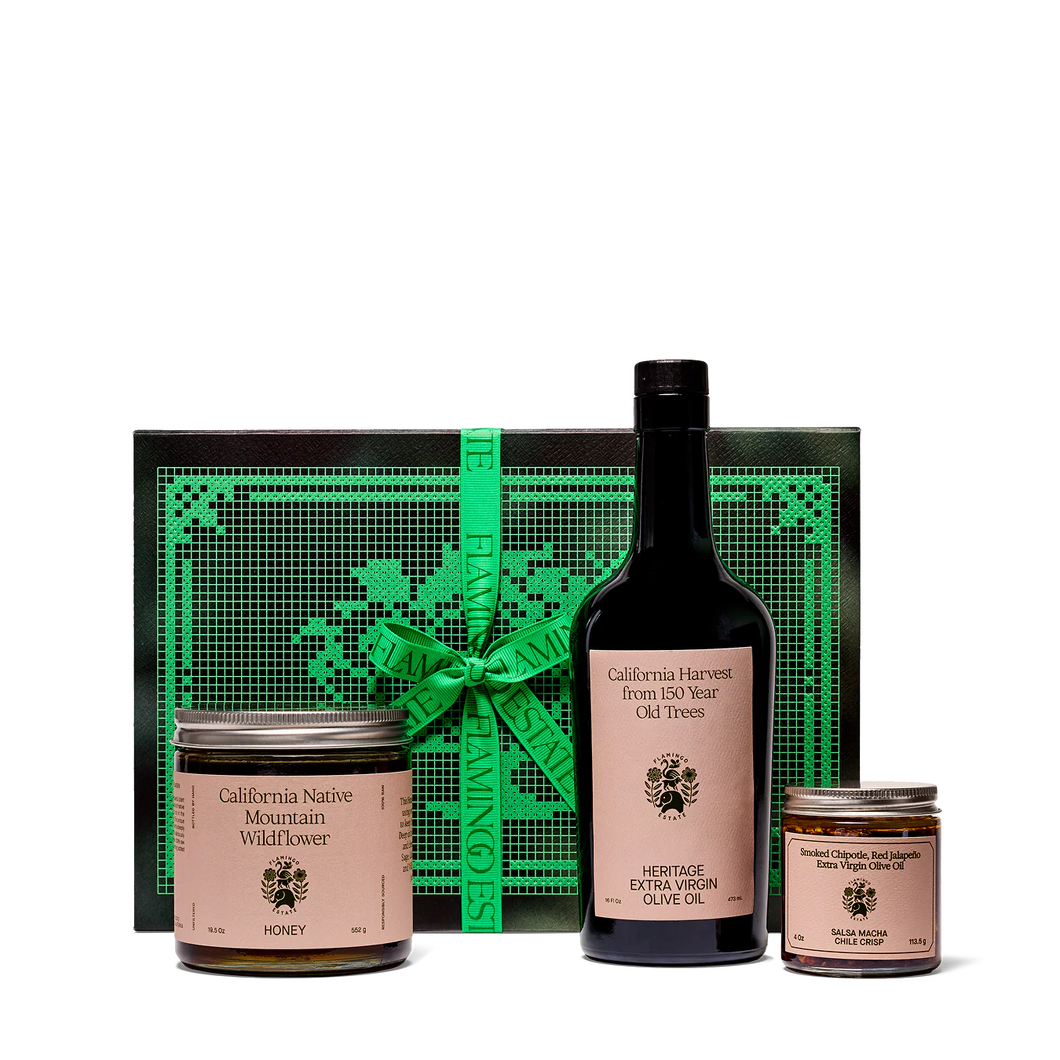 Gift set with olive oil, honey, and chile oil on a white background