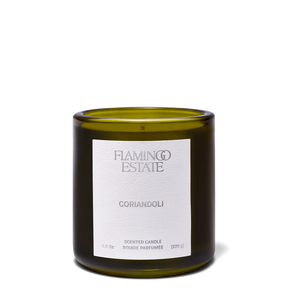 Green candle with a white label on a white background