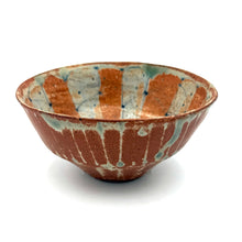 Ceramic bowl with brown and blue glaze on a white background
