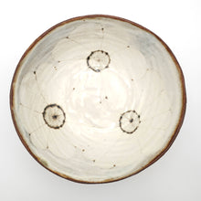 Ceramic bowl with circular patterns on a white background
