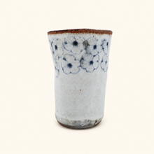 Spako Clay tumbler with blue floral patterns on a white background