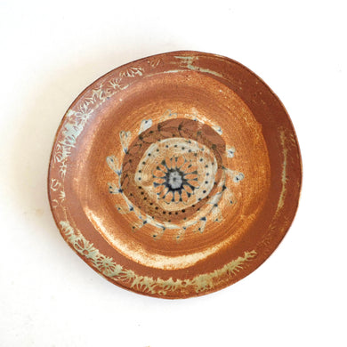 Ceramic plate with decorative patterns on a white background