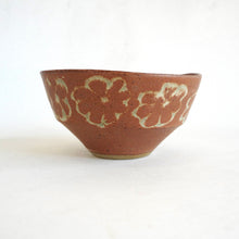 Ceramic bowl with floral patterns on a white background