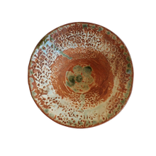 Ceramic bowl with decorative patterns on a white background