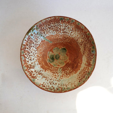 Ceramic plate with decorative patterns on a white background