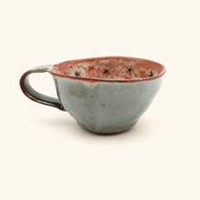 Ceramic cup with a textured surface on a white background