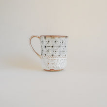 Spako Clay mug, geometric design. Mug handle on left