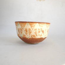 Ceramic bowl with a textured surface on a white background