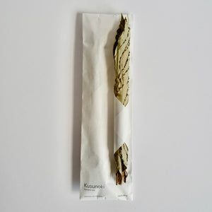 A camphor smudge incense with white paper bag packaging 