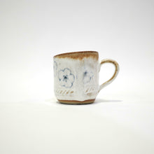 Spako Clay Espresso Cup blue and white glaze. Multiple blue flower Pattern. Handle on right
