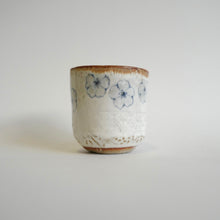 Spako Clay Wide Tumbler multiple blue flower on white glaze. Flower texture.