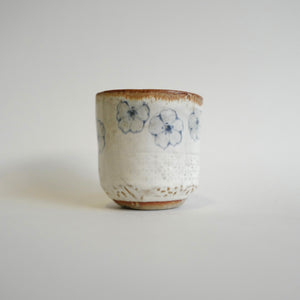 Spako Clay Wide Tumbler multiple blue flower on white glaze. Flower texture.