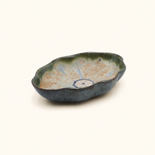 Ceramic dish with a textured surface on a white background