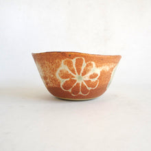 Ceramic bowl with a floral design on a white background