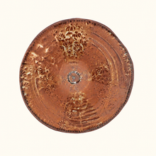 Ceramic bowl with intricate patterns on a white background