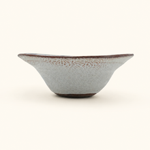 Ceramic bowl with textured surface on a white background