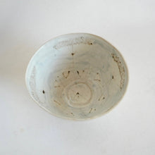 Ceramic bowl with wild floral design on a white background