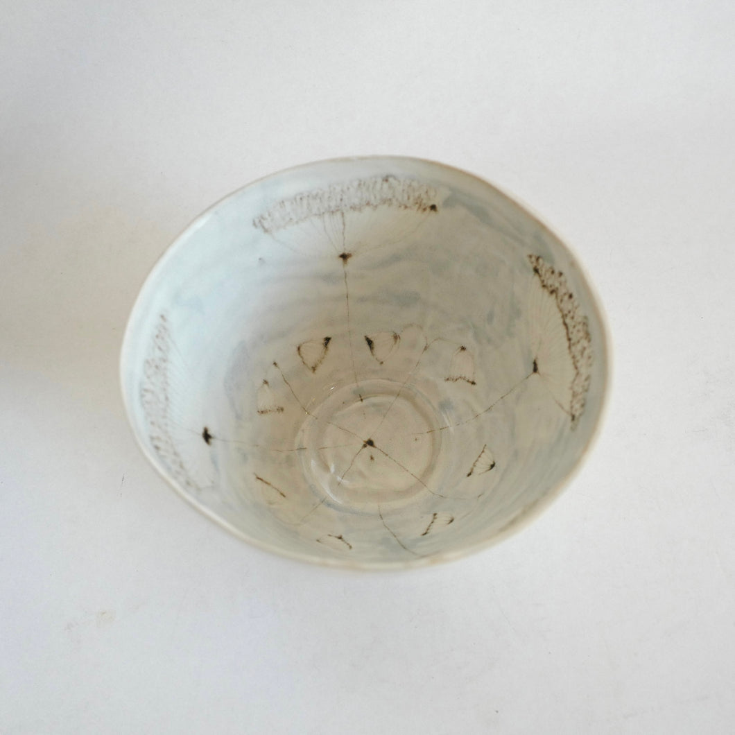 Ceramic bowl with wild floral design on a white background