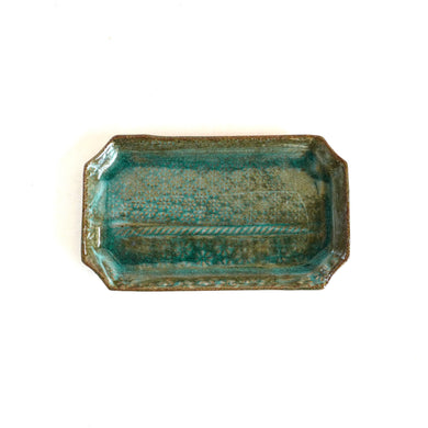 Rectangular ceramic tray with textured blue-green surface on a white background
